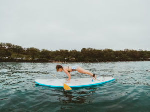 Attempting SUP yoga on a stand up paddle boarding tour with Maui SUP